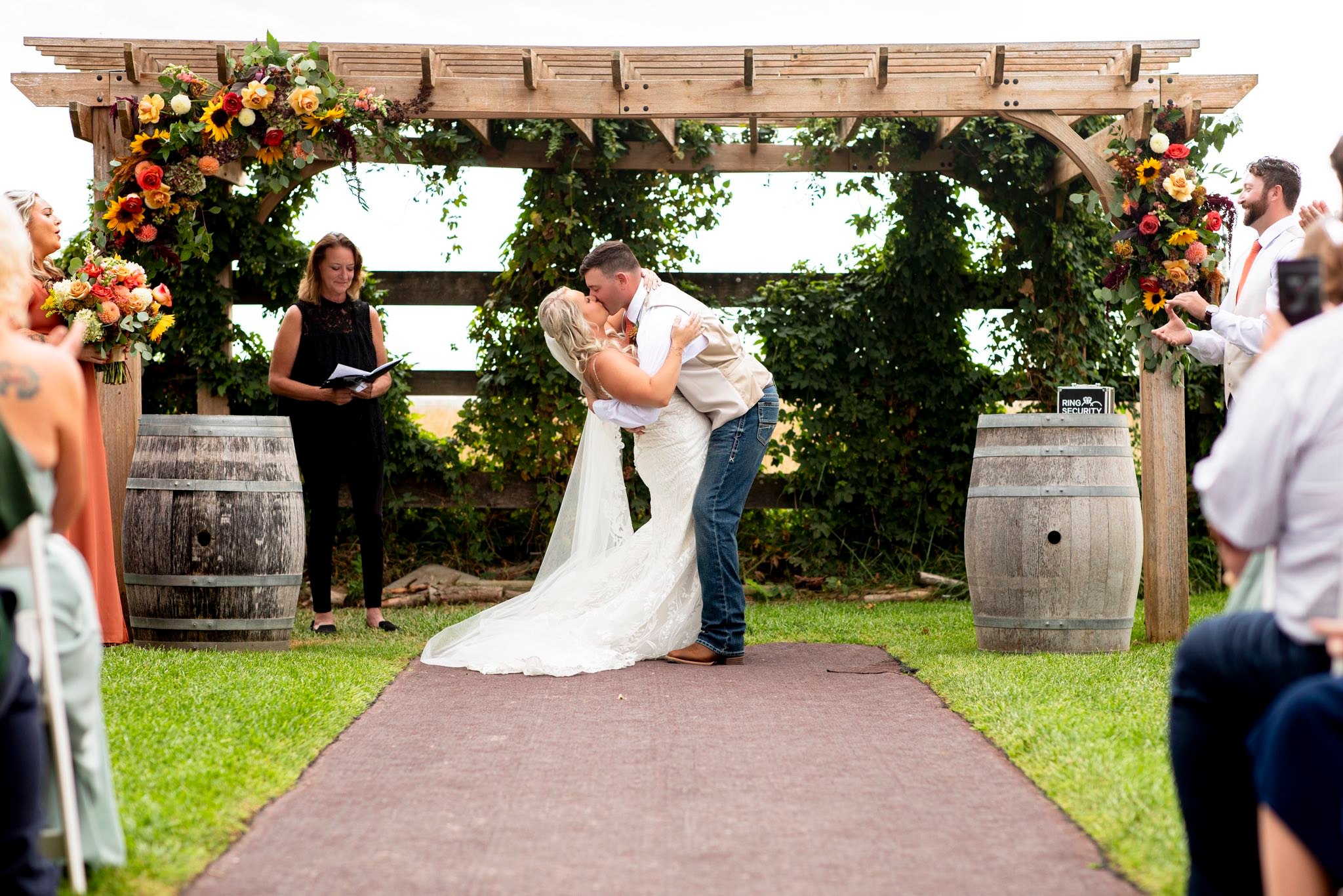 Newlyweds sharing their first kiss with Reverend Stacey Miles at Stone Ridge Estates in Pasco